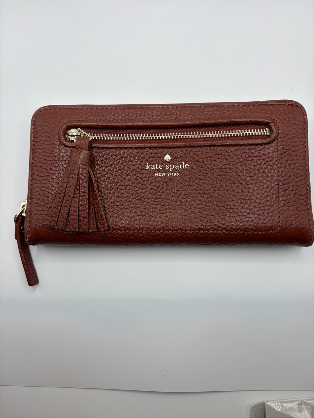 kate spade pebbled leather tassel zip-around wallet in deep brown